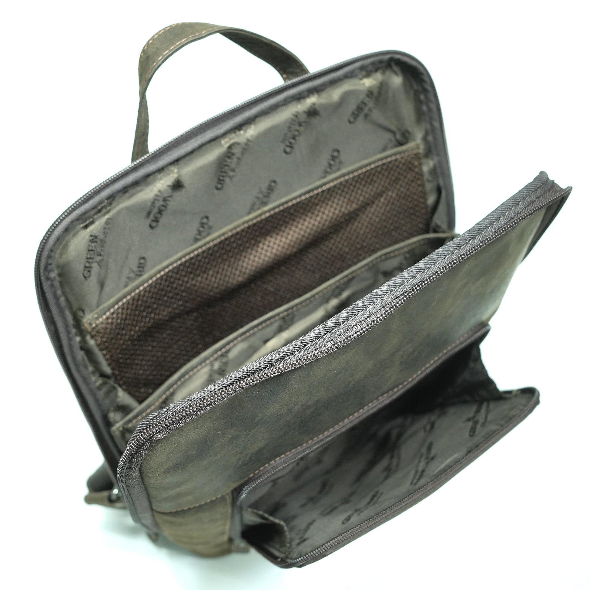 Open brown leather backpack showing interior compartments and laptop sleeve