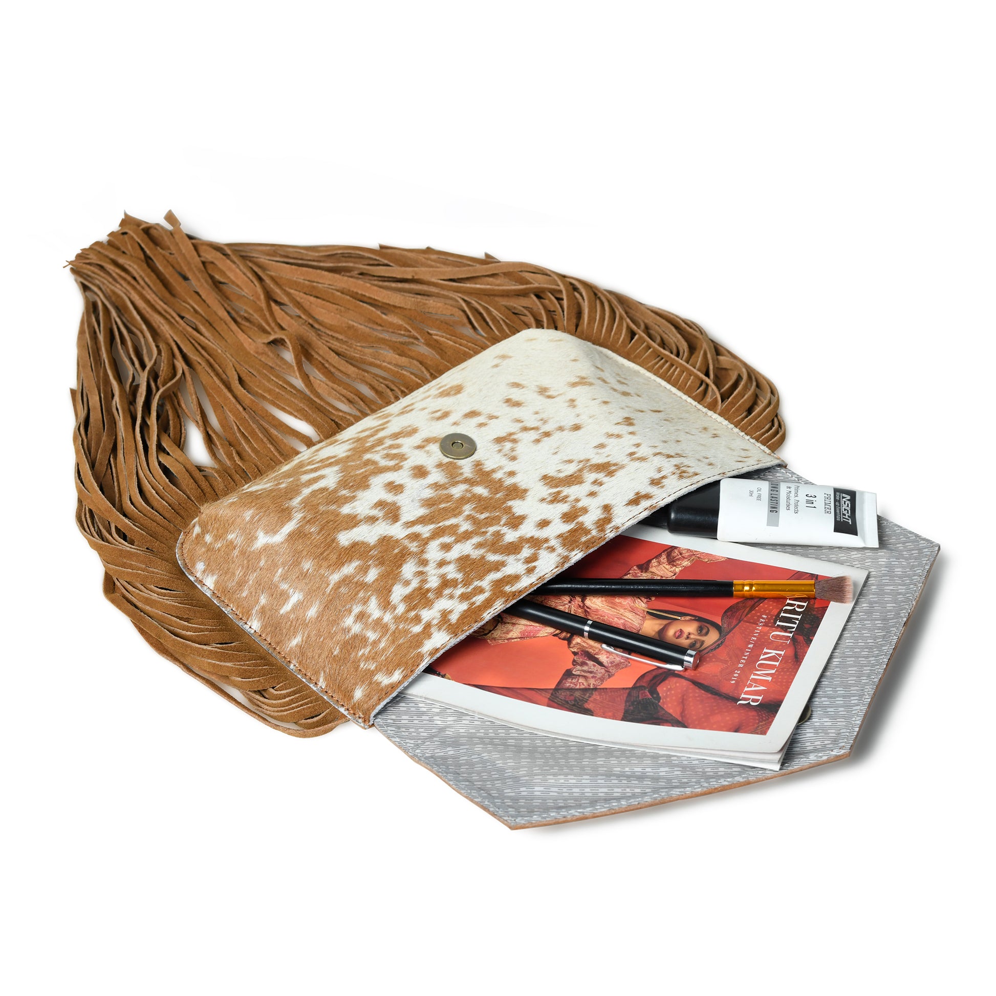 Tan cowhide crossbody bag inside stuff view